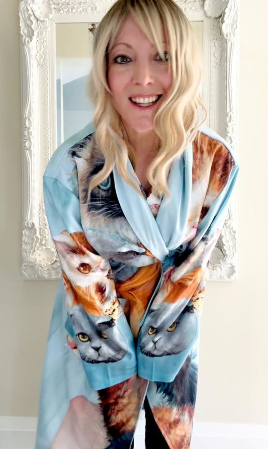 Woman wearing a bath robe with cat print design