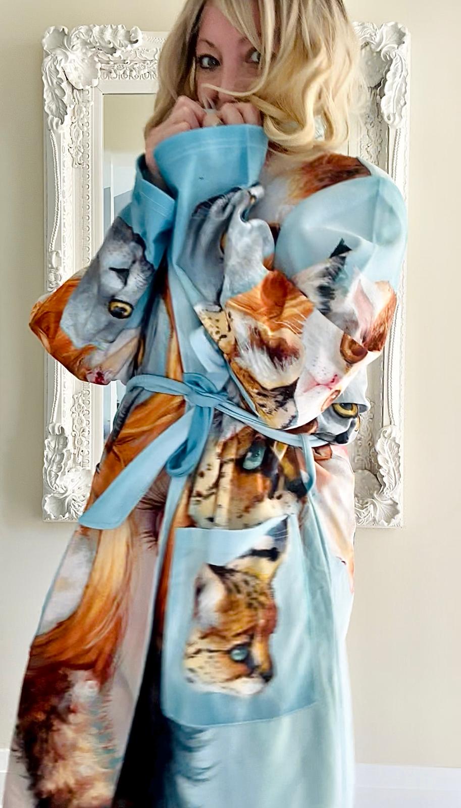 Woman wearing a robe with cat print design 