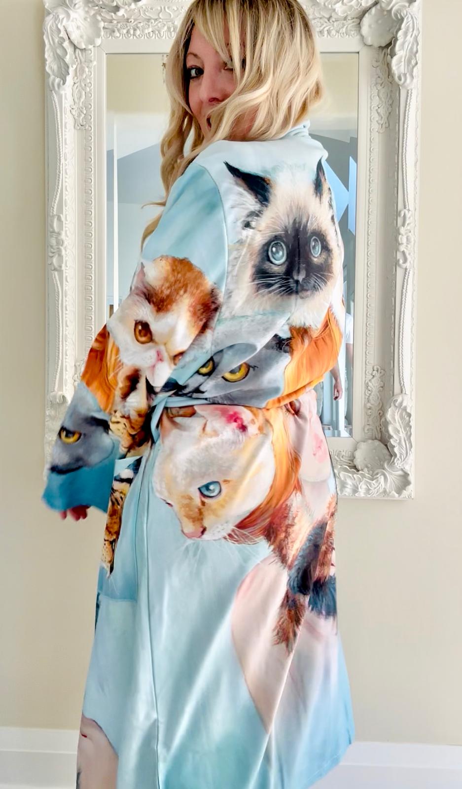 Woman wearing a bath robe with cat print  design